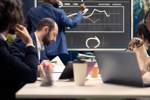 corporate-employees-examining-organizational-progress-meeting