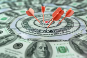 darts-hitting-bullseye-with-hundred-dollar-bill-as-target